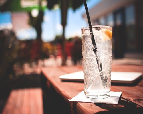 Fresh glass of water with ice on a sunny table